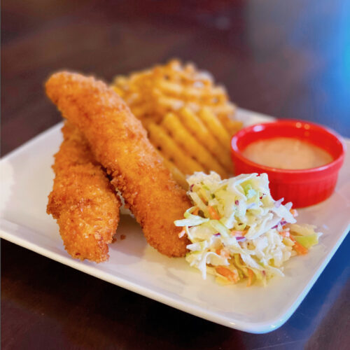 Photo of fried chicken with Cole slaw, waffle fries and sauce to illustrate Raising Canes Chicken Fingers Recipe