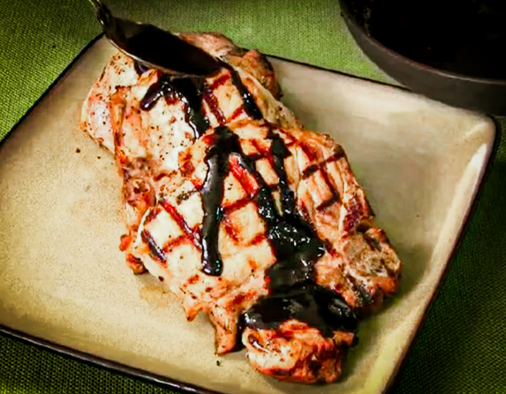 This Grilled Stuffed Pork Chops Recipe is topped with a balsamic glaze.
