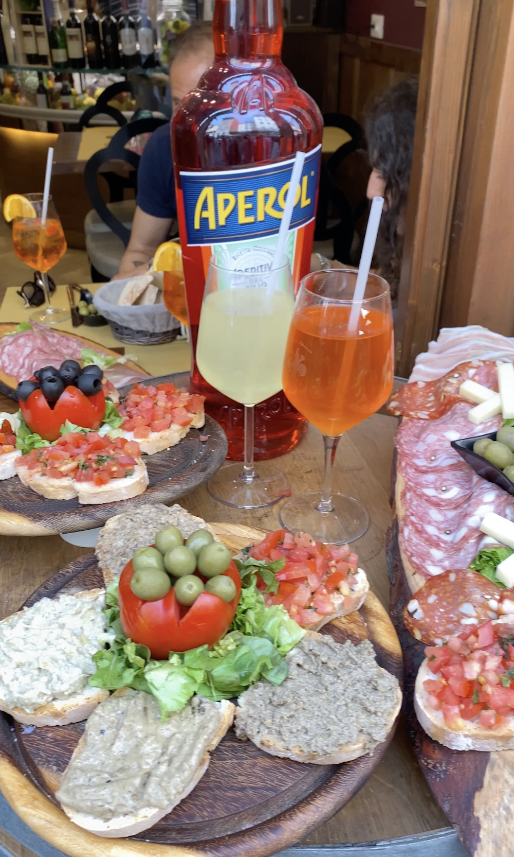 Photo of an Aperol Spritz in Florence with salami and olives
