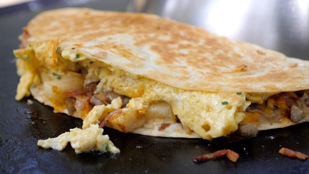 Photo of a loaded breakfast quesadilla on the grill