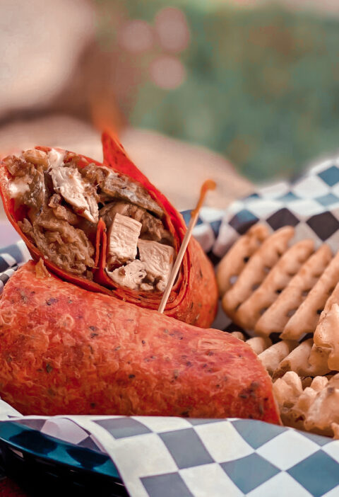 Photo of a Spicy Chicken Popper Wrap Recipe in a red tortilla with French fries