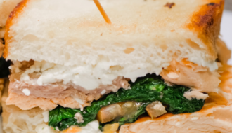 grilled salmon sandwich with spinach and feta cheese