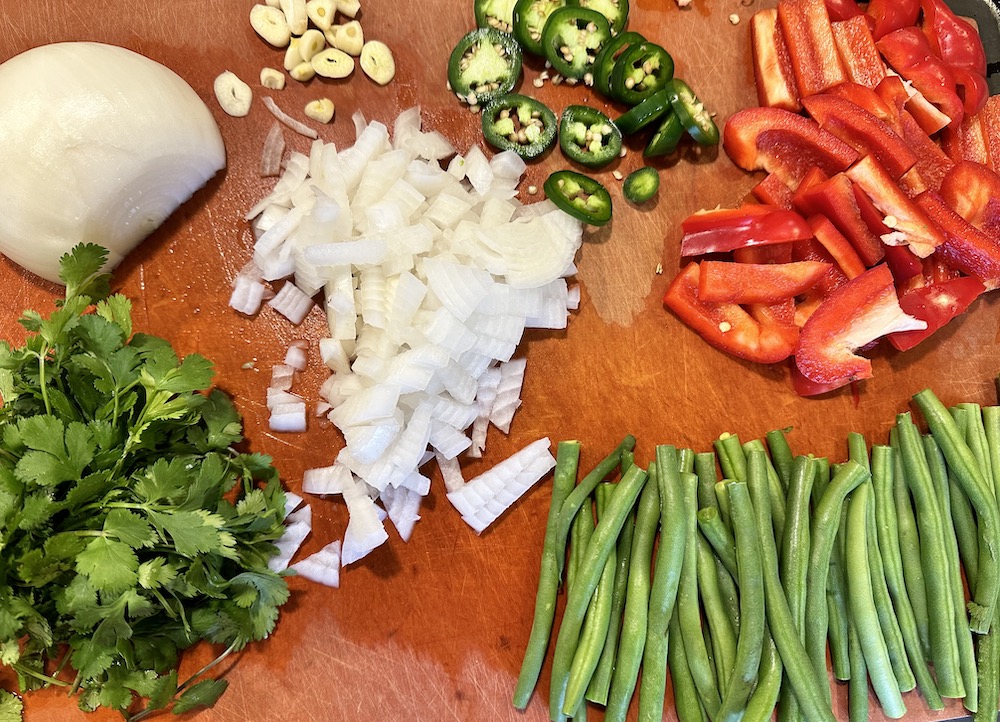 Onions, cilantro, garlic, red bell pepper and green beans for Quick Thai Red Curry