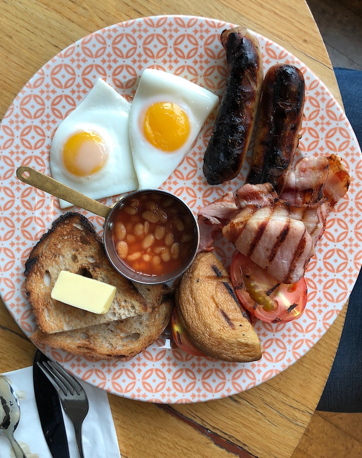 Full English Breakfast with eggs, beans, sausages, toast, grilled mushrooms, bacon and tomato.